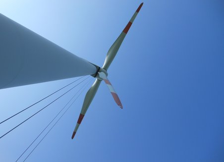 View from the earth upwards to a wind turbine.