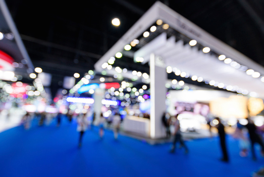 A trade fair stand in a hall is blurred.
