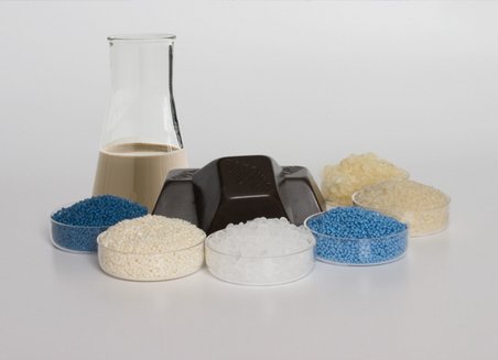 Different glass containers contain different colored solid and liquid materials.